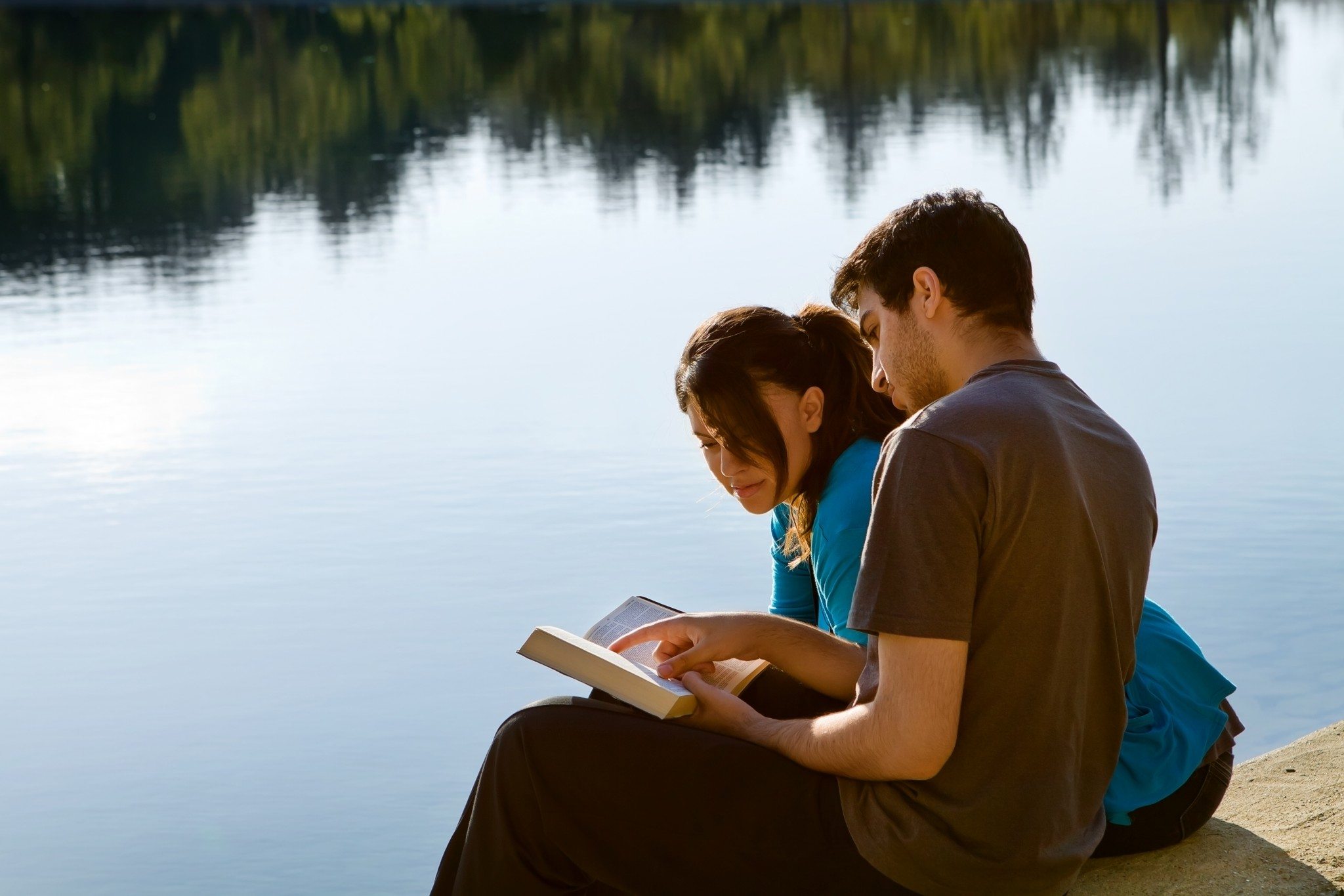 bigstock-Couple-Reading-The-Bible-By-A--45274390